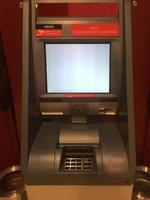 Front view of an ATM automated teller machine with white screen photo