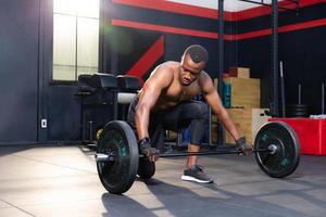 Fitness man lifting weights in gym fitness, Muscular man working out in gym doing exercises with barbell weight photo