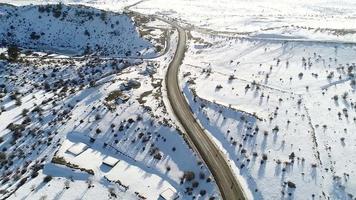 Asphalt road, snowy land. Long asphalt road in the snowy plain. video