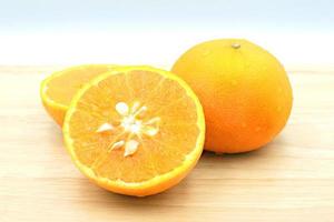 Fresh orange fruit on wooden table. photo