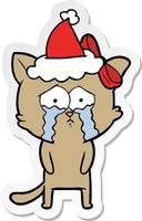 sticker cartoon of a cat wearing santa hat vector