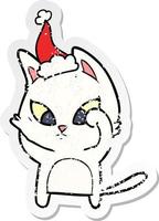 confused distressed sticker cartoon of a cat wearing santa hat vector