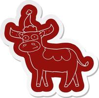 cartoon  sticker of a bull wearing santa hat vector