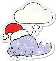 cartoon christmas walrus and thought bubble as a distressed worn sticker vector