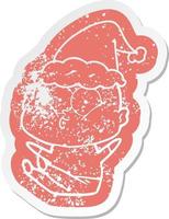 cartoon distressed sticker of a bald man staring wearing santa hat vector