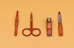 Set for cutting nails. Tools of a manicure set on a beige background photo