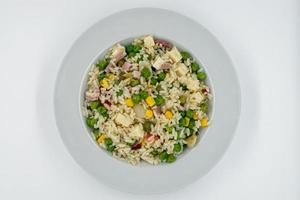 Italian Cold Rice Salad, Riso Freddo. Fresh and healthy summer salad on white background. Top view photo