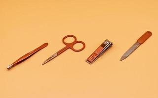 Set for cutting nails. Tools of a manicure set on a beige background photo