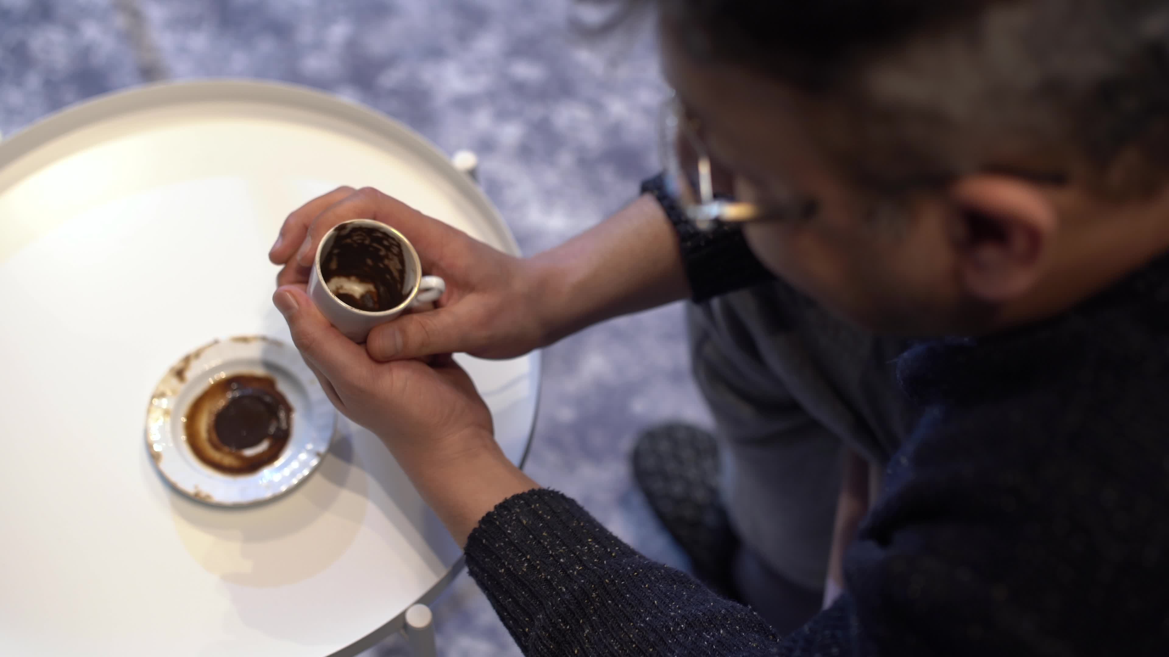 Coffee fortune telling. The fortune teller who looks at the coffee