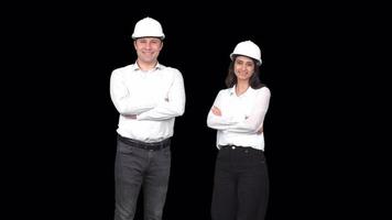 A male and a female engineer looking at the camera and laughing. Engineers looking at camera and smiling, crossing their arms. Transparent background. video