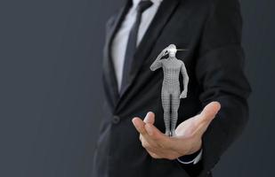 Businessman holding intelligence artificial or robot photo