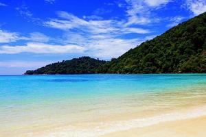 Clear sea and mountain with blue sky clouds on the summer day at Koh Lipe island, Satun, Thailand. Nature and Beautiful Landscape photo