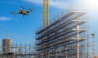 Drone over construction site. video surveillance or industrial inspection photo