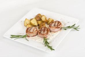 Grilled steak wrapped in bacon, with grilled vegetables, mashed potatoes photo