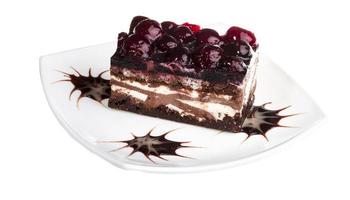 Chocolate cake with cherry on top on a white background photo