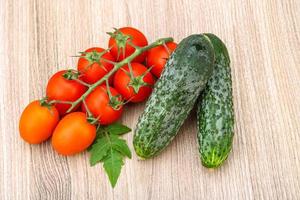 Cucumbers and tomatoes on the branch photo