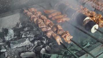 Grilled meats, skewers and wings. Meat is cooked on charcoal. Meat skewers, adana kebab, chicken wings and vegetables.