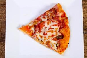 Pizza with sausages and tomato photo