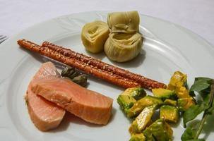 Salmon with avocado and artichoke photo