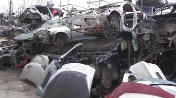 Scrapped cars, crashed cars. Scrap cars are used for recycling and second-hand spare parts. Pile of scrap vehicles.