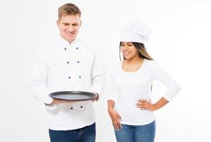 Male and female cooks in uniform hold empty tray isolated on white background photo
