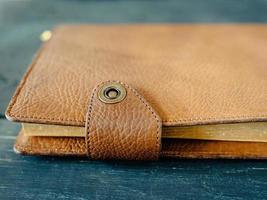 leather handmade notebook organizer on dark wooden background photo