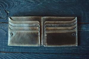 leather handmade craft vintage wallet on gray wooden background photo