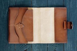 leather handmade notebook organizer on dark wooden background photo