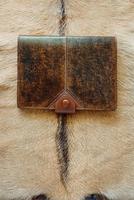 leather handmade notebook organizer on leather and fur background photo