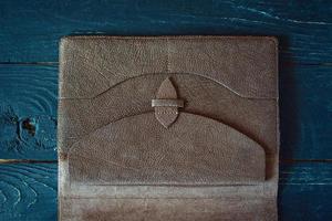 leather handmade notebook organizer on dark wooden background photo