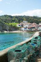 Beautiful view of Tazones, a fisherman village in Asturias. Fishing cages in the harbour photo