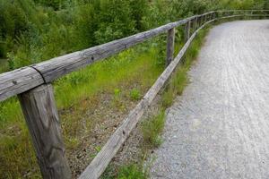 wooden fence with little road photo
