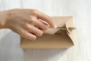 Hands holding an empty cardboard box photo