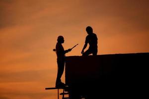 Silhouettes of worker welder photo