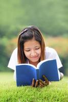 Young woman open a book in outdoor photo