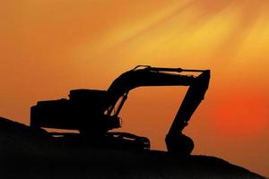 Silhouetted Digging Machine photo