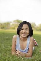 Asian little girl relax and smiling happily in the park photo