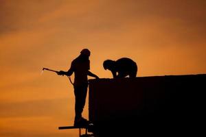 Silhouettes of worker welder photo