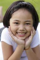 Asian little girl relax and smiling happily in the park photo