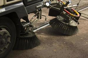 Street sweeper cleaning in urban area photo