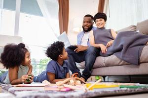 Family relaxing and playing in the living room on the floor in weekend photo