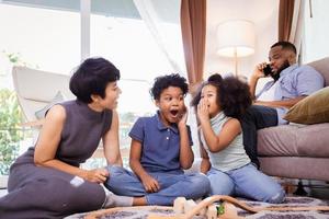 Funny African American family. Relaxing and playing in living room together photo