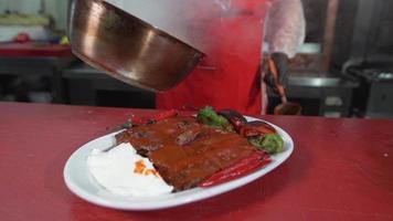 Turkey Iskender kebab.  Pouring sauce on meat. Butter sauce. video