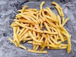 French fries on black background, close up top view, fast food photo