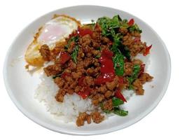 Stir fried minced pork and chili mix with basil isolated on white background photo