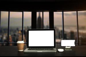 Front view workspace with computer, smartphone and tablet on white desk with blurred background photo