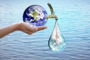 World Water Day. Water out of the tap. To preserve the environment for sustainability photo