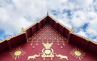 Carved pattern in the traditional Thai style on the gable of the Thai church. photo