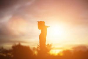 silueta de niño, momentos de alegría del niño. en la puesta de sol de la naturaleza foto