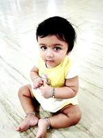 A cute little baby girl in joy mood photo